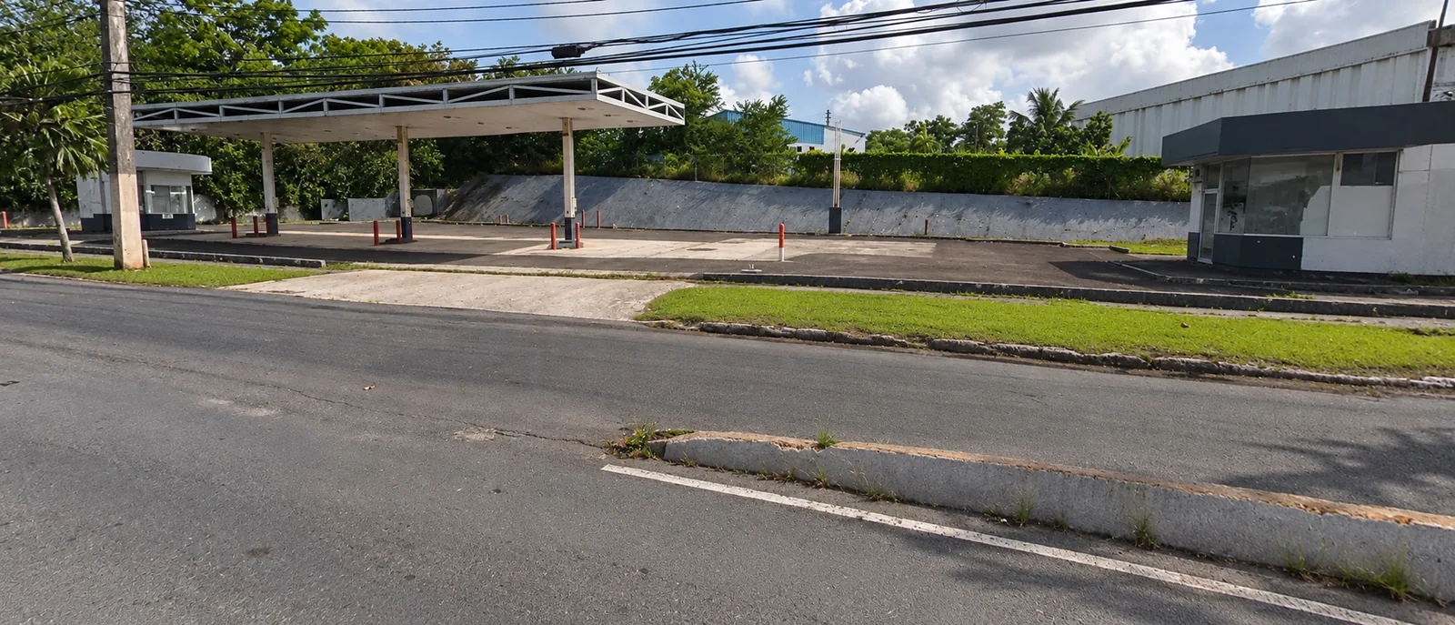 Existing vacant gasoline service station, with vehicle and mapping arrows removed